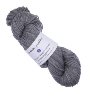 skein of mid grey hand dyed DK weight wool yarn with The Knitting Goddess ball band
