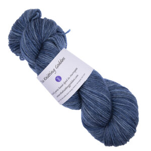 skein of navy hand dyed DK weight wool yarn with The Knitting Goddess ball band