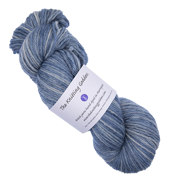 skein of slate hand dyed DK weight wool yarn with The Knitting Goddess ball band