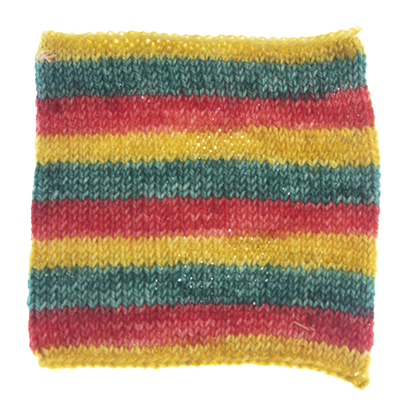 knitted swatch showing self striping sock yarn with equal stripes of red, gold and green