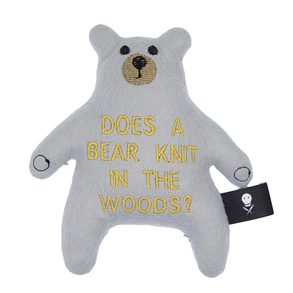 silver felt bear embroidered with "DOES A BEAR KNIT IN THE WOODS?"