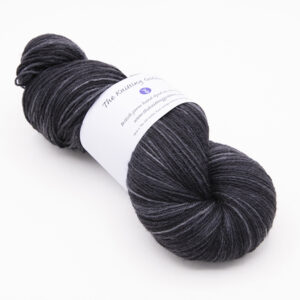 skein of hand dyed black yarn with The Knitting Goddess label