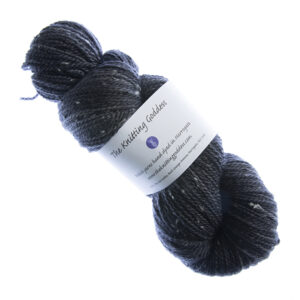 skein of hand dyed coal black tweed yarn with The Knitting Goddess label