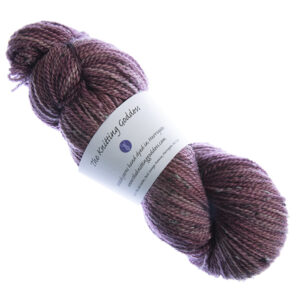 skein of hand dyed dark red tweed yarn with The Knitting Goddess label