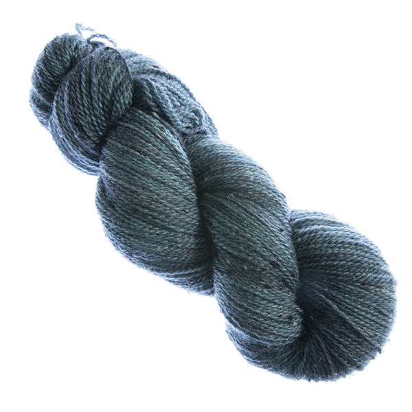 skein of hand dyed dark teal tweed yarn with The Knitting Goddess label