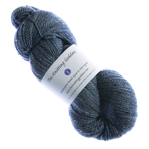skein of hand dyed navy tweed yarn with The Knitting Goddess label