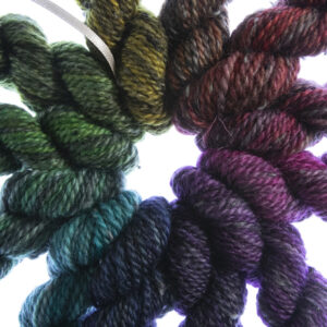 close up of twelve mini skeins making up a printer ink shades colour wheel