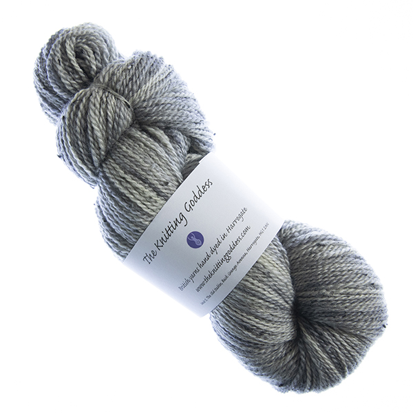 skein of hand dyed silver tweed yarn with The Knititng Goddess label
