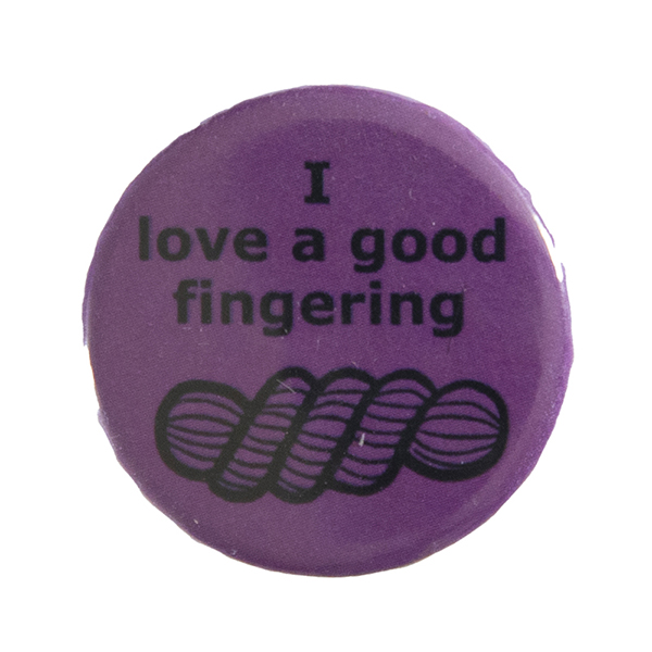 pink pin badge with text "I love a good fingering" and a line drawing of a skein of yarn