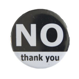 black and grey pin badge with text "NO thank you"