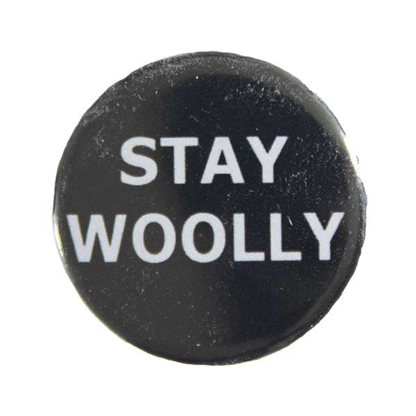 black pin badge with text "STAY WOOLLY"