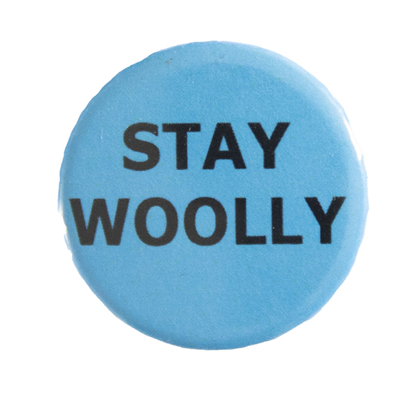 blue pin badge with text "STAY WOOLLY"