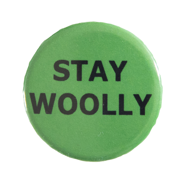 green pin badge with text "STAY WOOLLY"