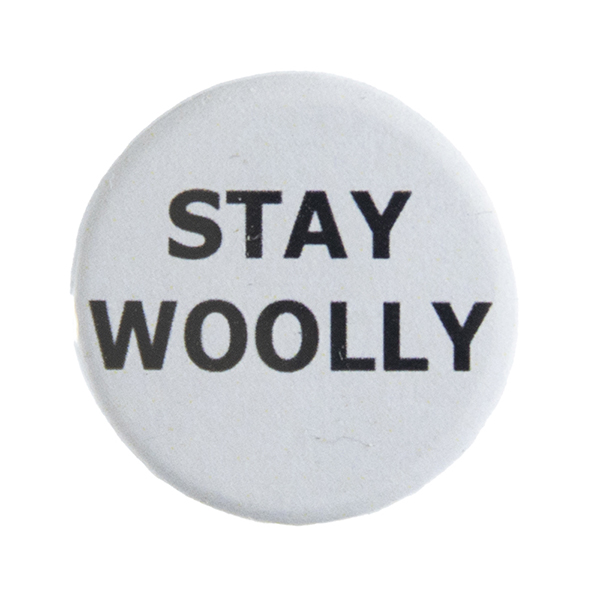 grey pin badge with text "STAY WOOLLY"