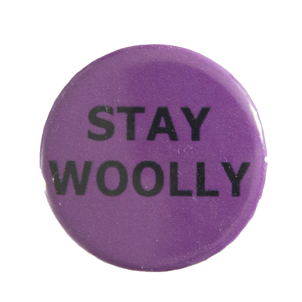 pink pin badge with text "STAY WOOLLY"