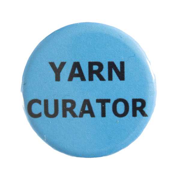 blue pin badge with text "YARN CURATOR"