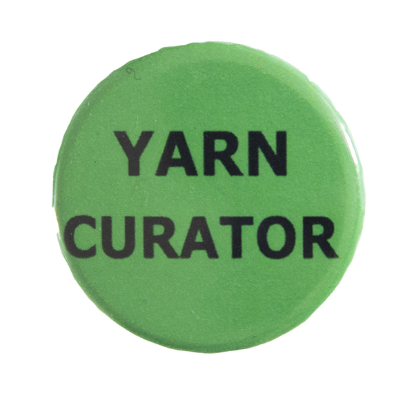 green pin badge with text "YARN CURATOR"