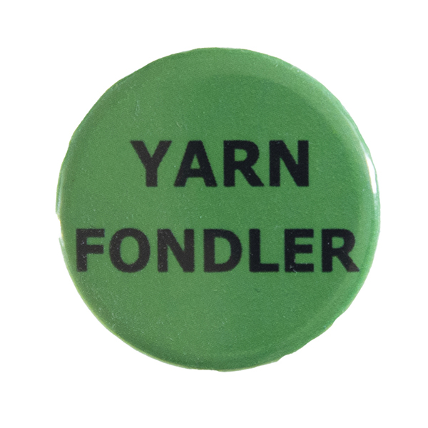 green pin badge with text "YARN FONDLER"
