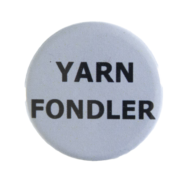 grey pin badge with text "YARN FONDLER"