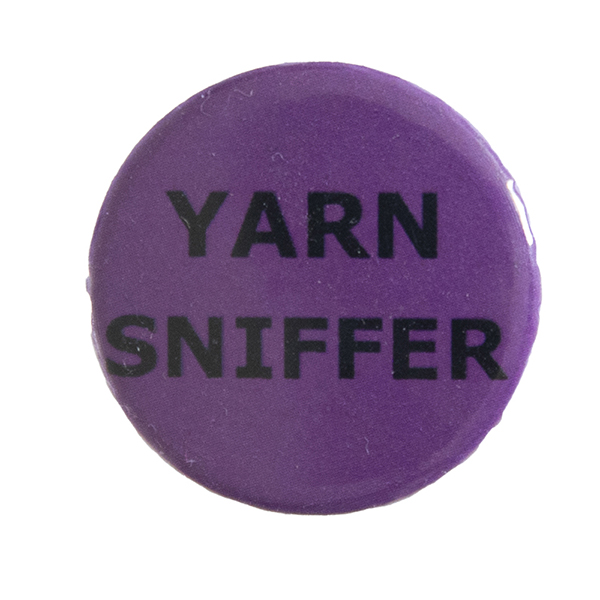 pink pin badge with text "YARN SNIFFER"