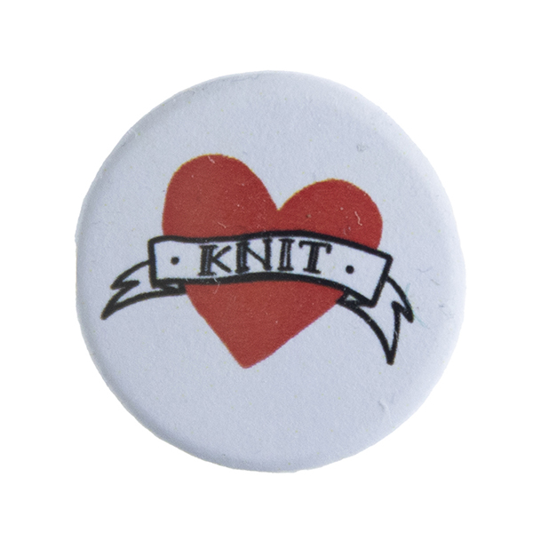 badge with tattoo style heart and banner with text "KNIT"