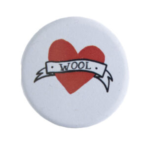 badge with tattoo style heart and banner with text "WOOL"