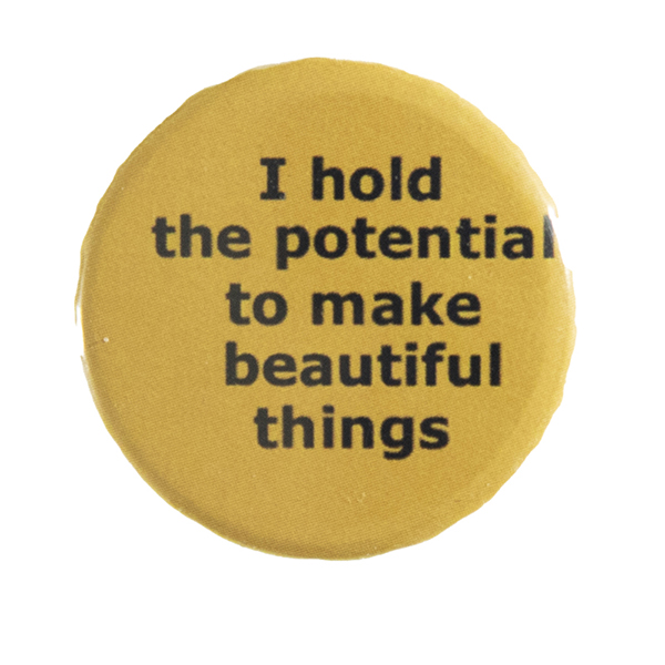 yellow pin badge with text "I hold the potential to make beautiful things"