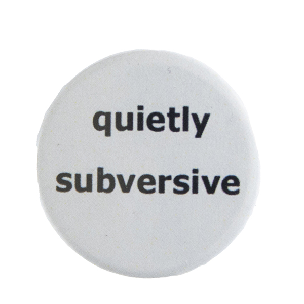 grey pin badge with text "quietly subversive"