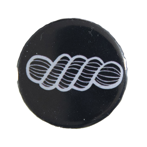 black pin badge with line drawing of a skein of yarn