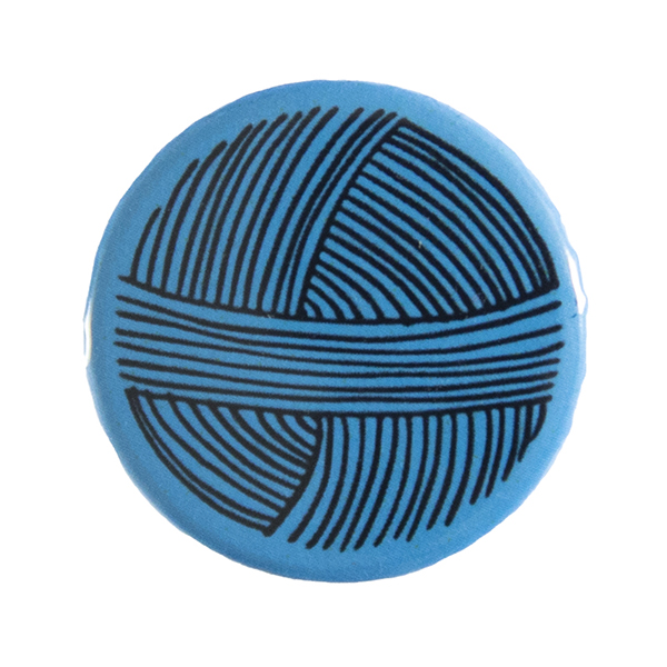 blue pin badge with line drawing of a ball of yarn