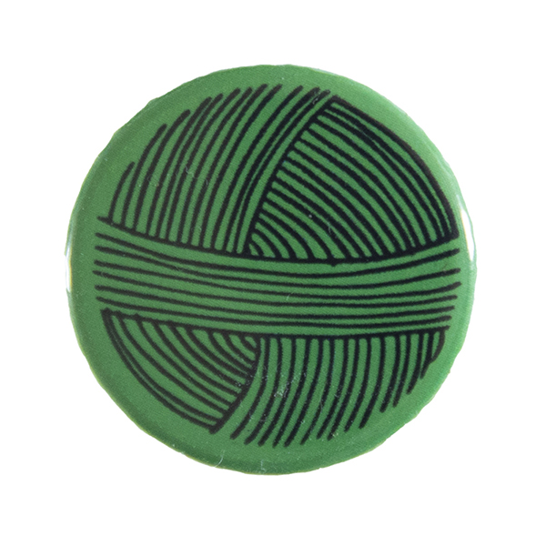 green pin badge with line drawing of a ball of yarn