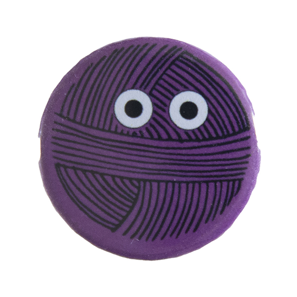 pink pin badge with line drawing of a ball of yarn with eyes