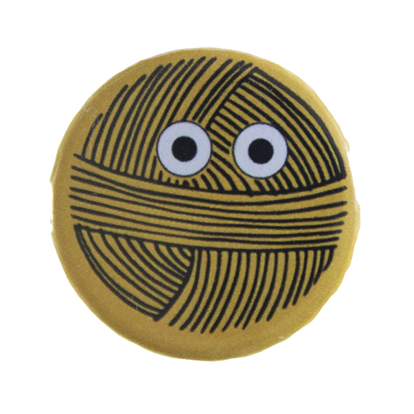 yellow pin badge with line drawing of a ball of yarn with eyes