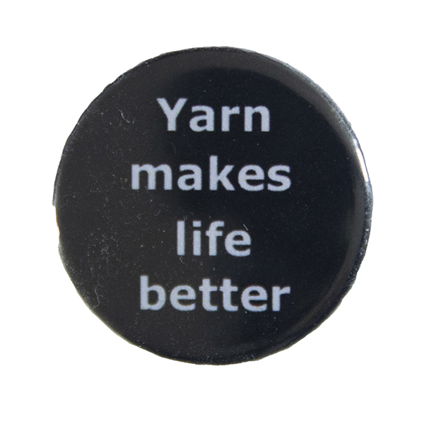 black pin badge with text "Yarn makes life better"