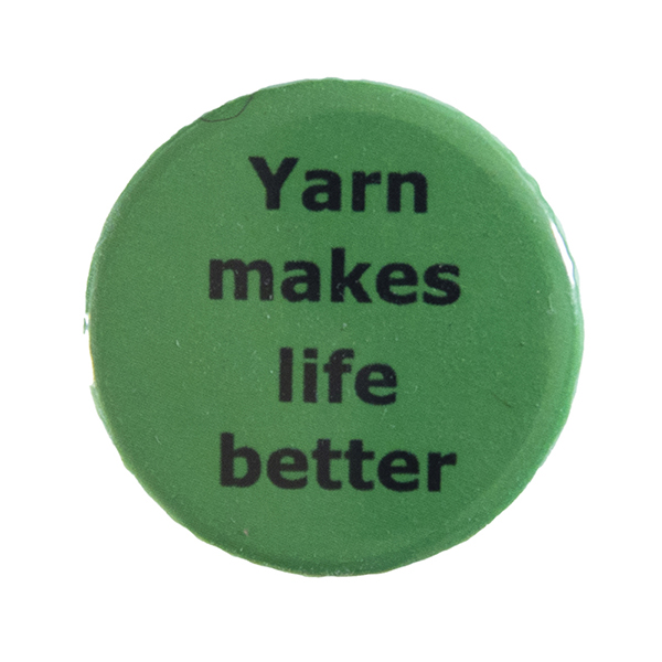 green pin badge with text "Yarn makes life better"
