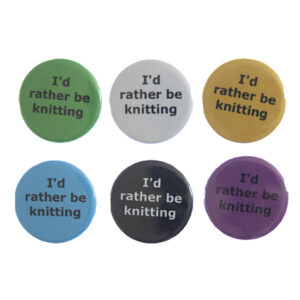 pin badges with text "I'd rather be knitting". Badges are green, light grey, yellow. blue, black and pink