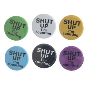 pin badges with text "SHUT UP I'm counting". Badges are green, light grey, yellow. blue, black and pink