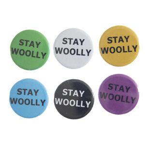 pin badges with text "STAY WOOLLY". Badges are green, light grey, yellow. blue, black and pink