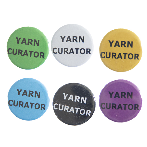 pin badges with text "YARN CURATOR". Badges are green, light grey, yellow. blue, black and pink