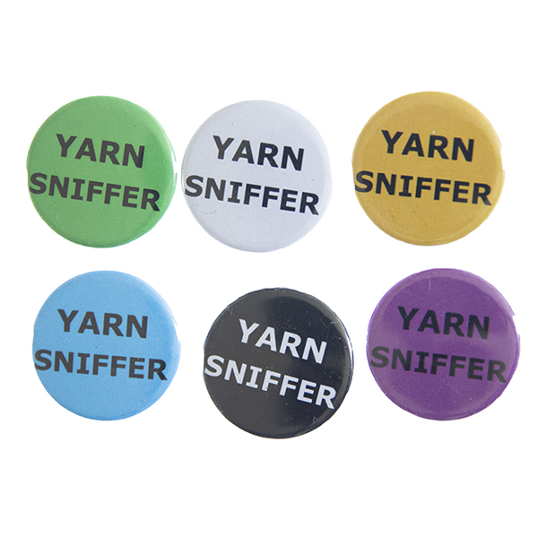 pin badges with text "YARN SNIFFER". Badges are green, light grey, yellow. blue, black and pink