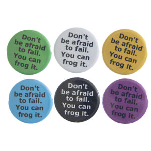 pin badges with text "Don't be afraid to fail. You can frog it". Badges are green, light grey, yellow. blue, black and pink