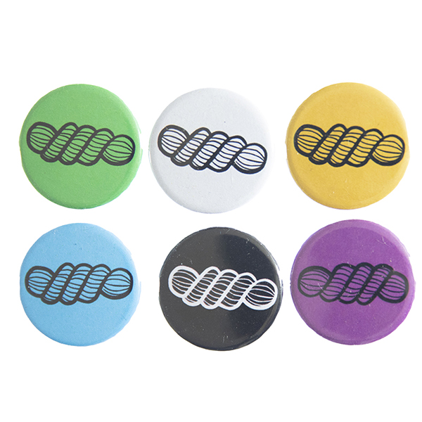 pin badges with line drawing of a skein of yarn.. Badges are green, light grey, yellow. blue, black and pink