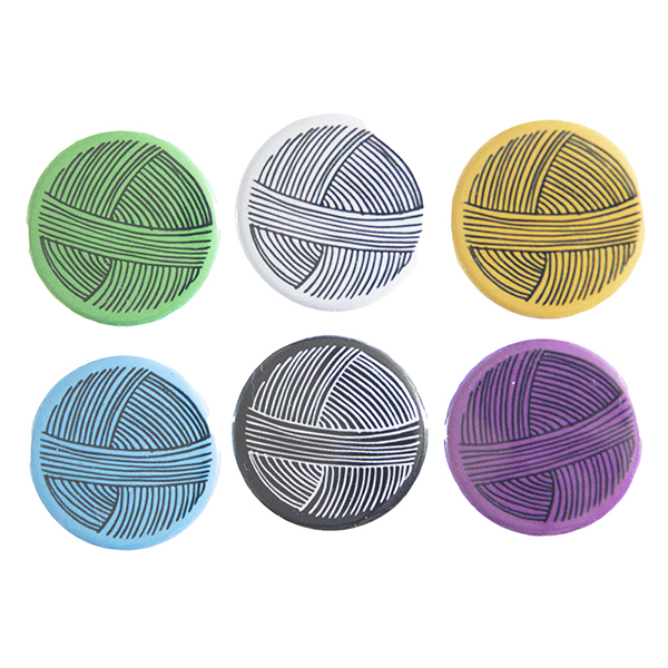 pin badges with line drawing of a ball of yarn". Badges are green, light grey, yellow. blue, black and pink