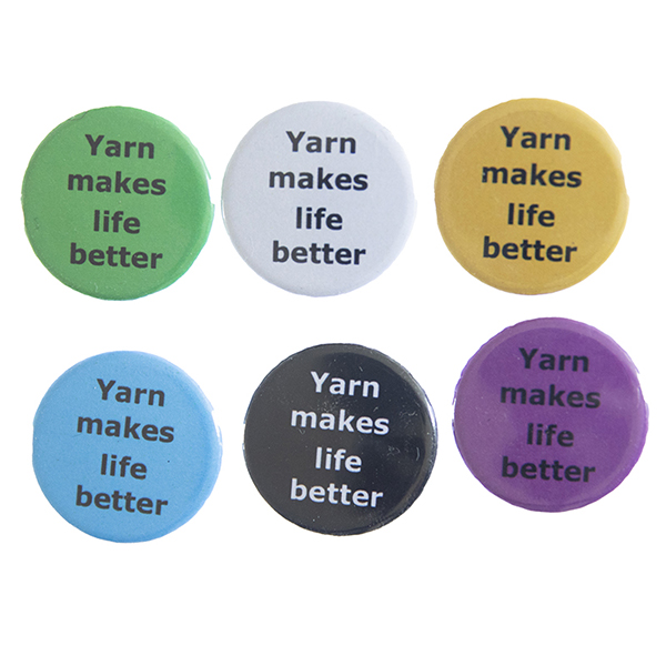 pin badges with text "Yarn makes life better". Badges are green, light grey, yellow. blue, black and pink