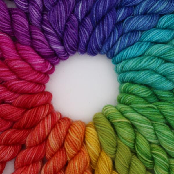 24 mini skeins making up a colour wheel. Arranged in a circle, photographed from above