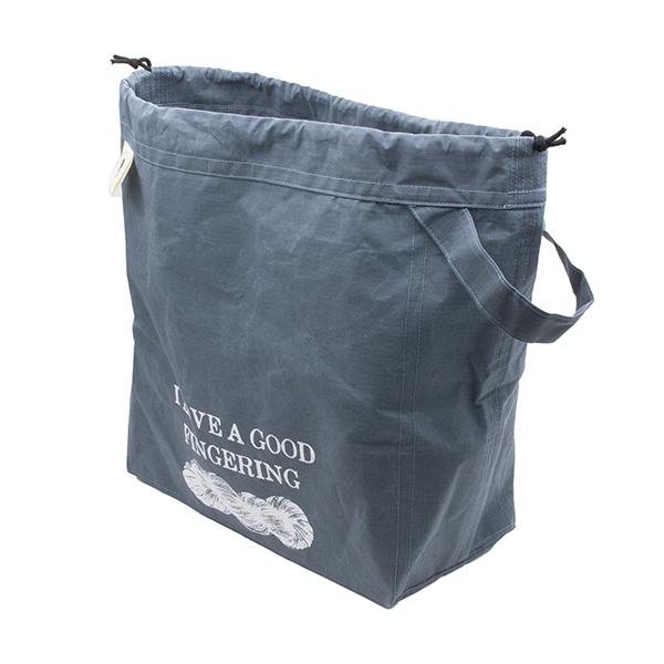 large drawstring project bag in slate blue fabric, wrist strap, drawstring closure, screen printed with text "I LOVE A GOOD FINGERING" and a skein of yarn
