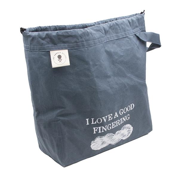 large drawstring project bag in slate blue fabric, wrist strap, drawstring closure, screen printed with text "I LOVE A GOOD FINGERING" and a skein of yarn