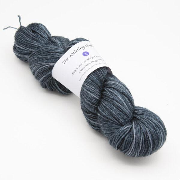 skein of blackened green Bluefaced Leicester wool, The Knitting Goddess ball band