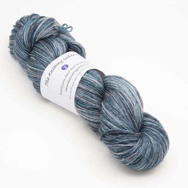 skein of blackened turquoise Bluefaced Leicester wool, The Knitting Goddess ball band