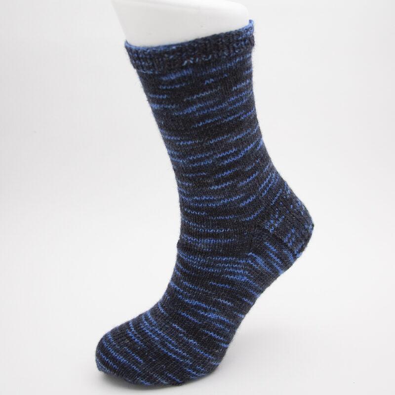 hnd knitted sock in black and blue Tories Are Toxic yarn